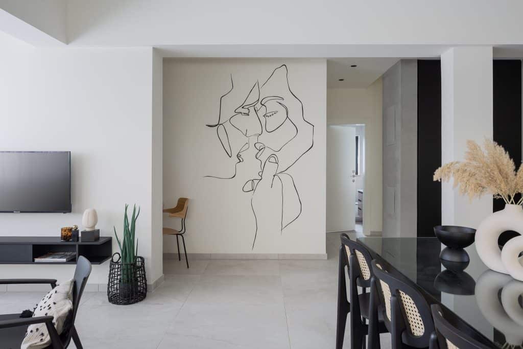 Dining area with a wooden table and chairs in a professionally managed TLV2GO apartment in Tel Aviv