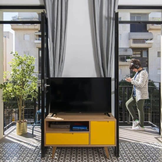 Living room opening to balconies over Tel Aviv's Old North at Mr. Brooklyn, 288 Dizengoff St