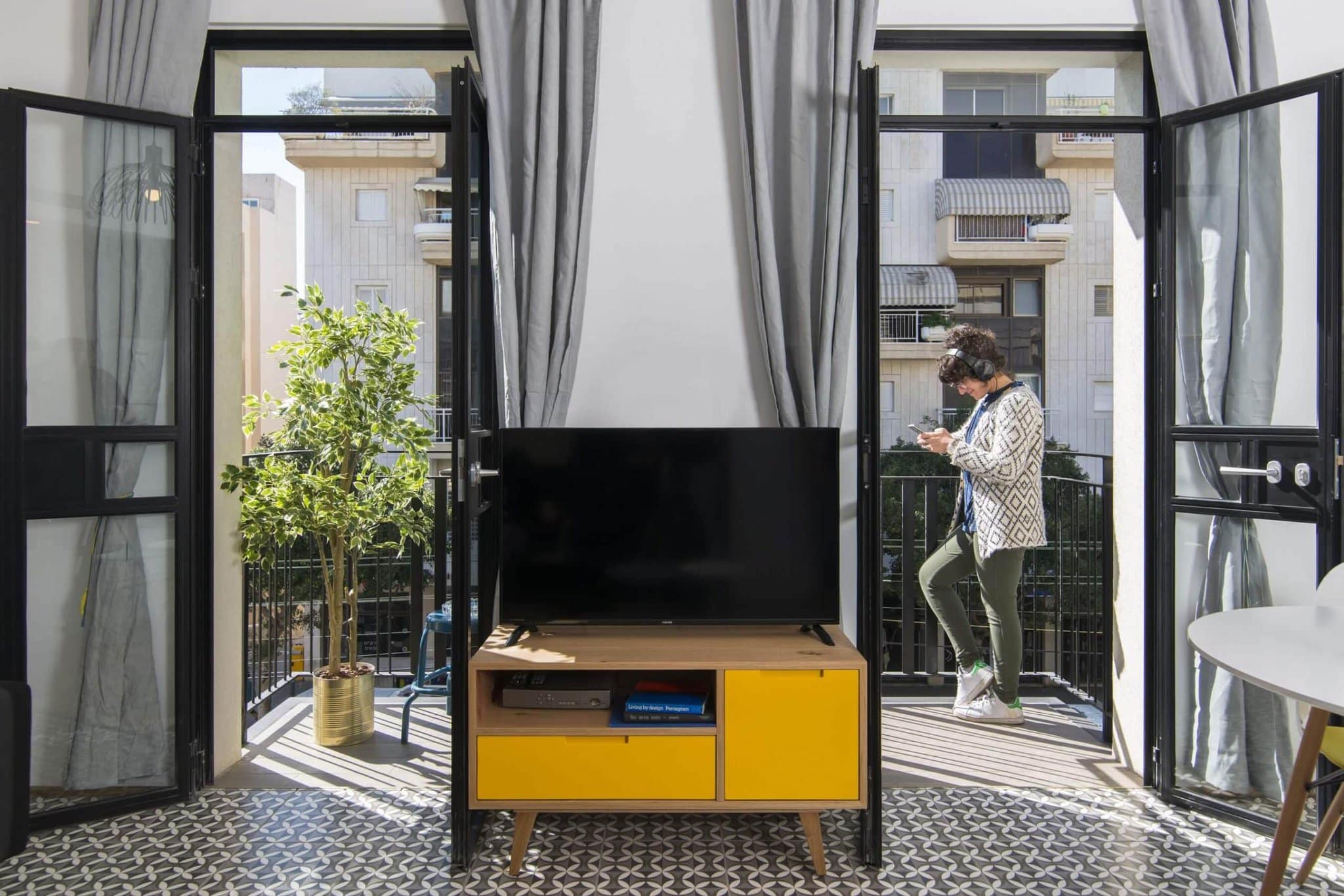 Living room opening to balconies over Tel Aviv's Old North at Mr. Brooklyn, 288 Dizengoff St
