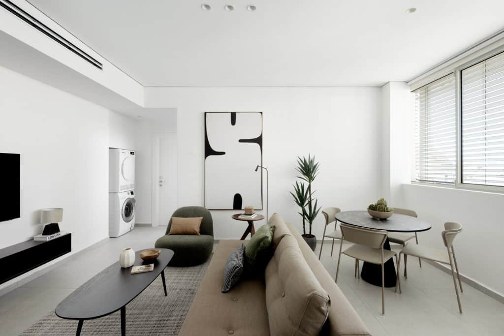 Living and dining room with an in-unit washer and dryer in a furnished TLV2GO apartment in Tel Aviv